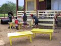 Volunteers painting a school house
