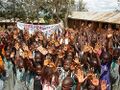 Students wave and show a banner from their sister school in the US
